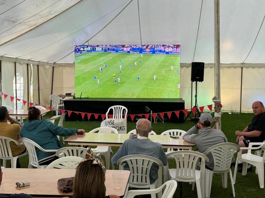 A Medium sized led screen showing the football to an audience.